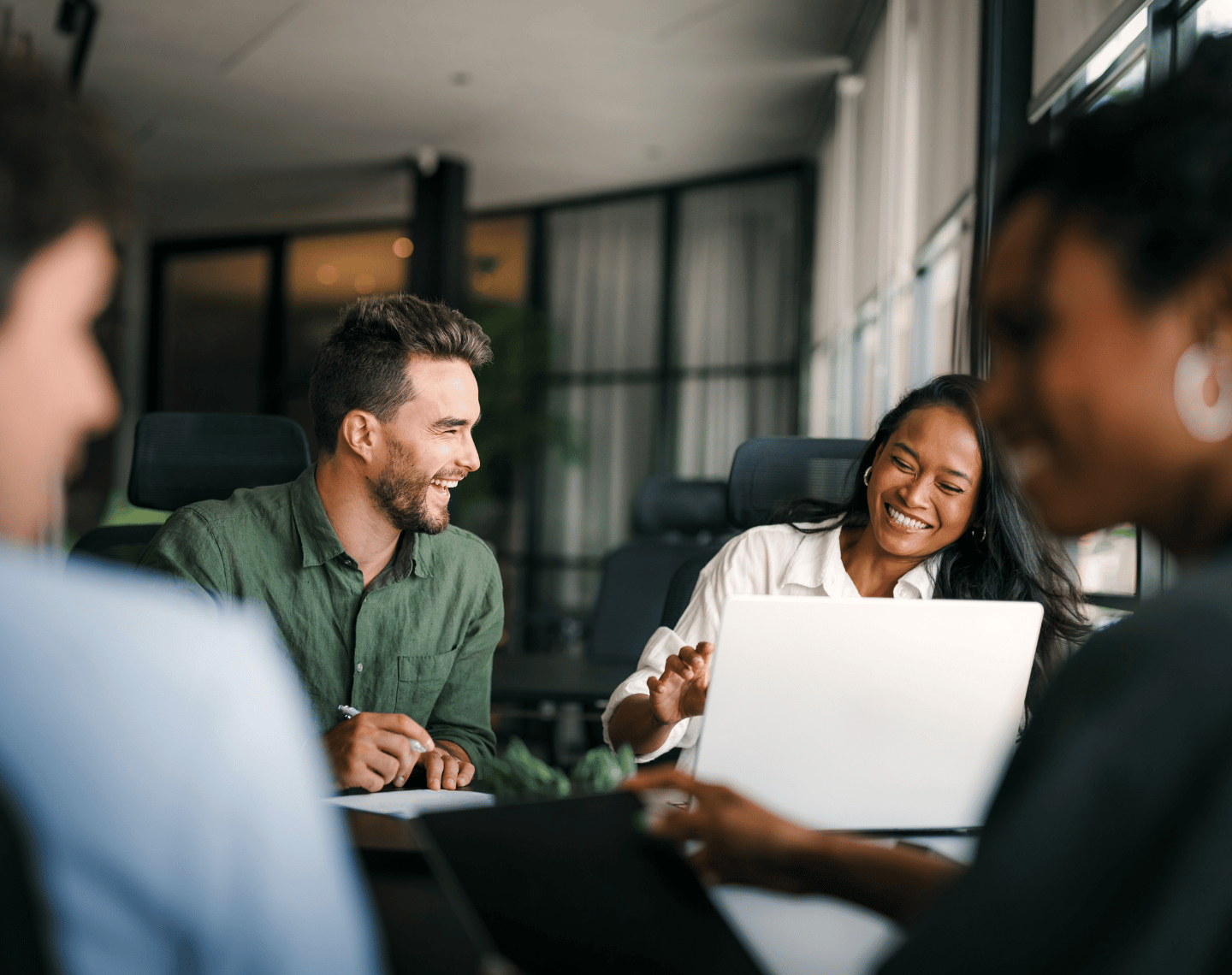 Group of Coworkers Smiling and Laughing in an Office