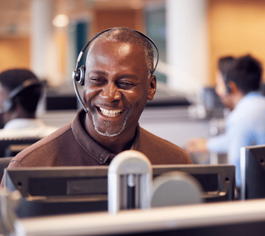 Customer Support Man Smiling with a Headset On