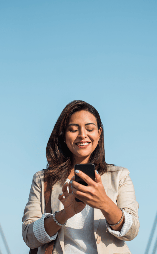 Professional Woman Smiling While on Phone on a Walk