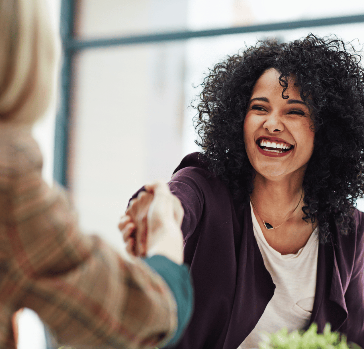 Woman Shaking Hands Smiling in a Formal Setting