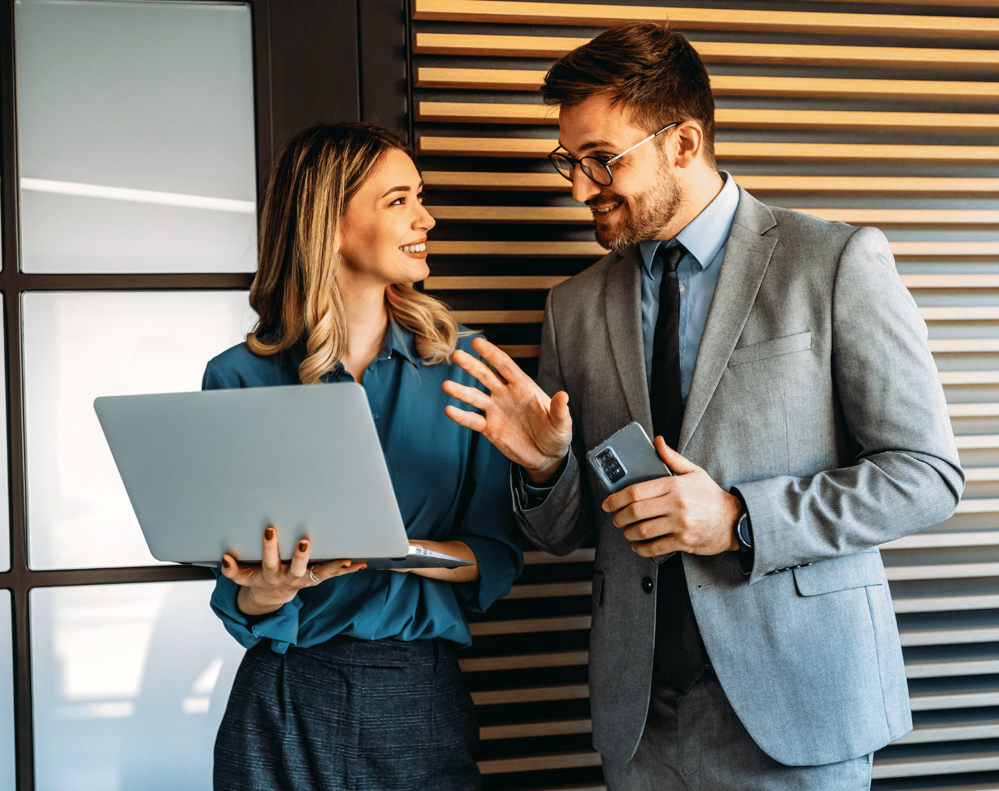 Two Young Professionals Looking at Laptop in Office