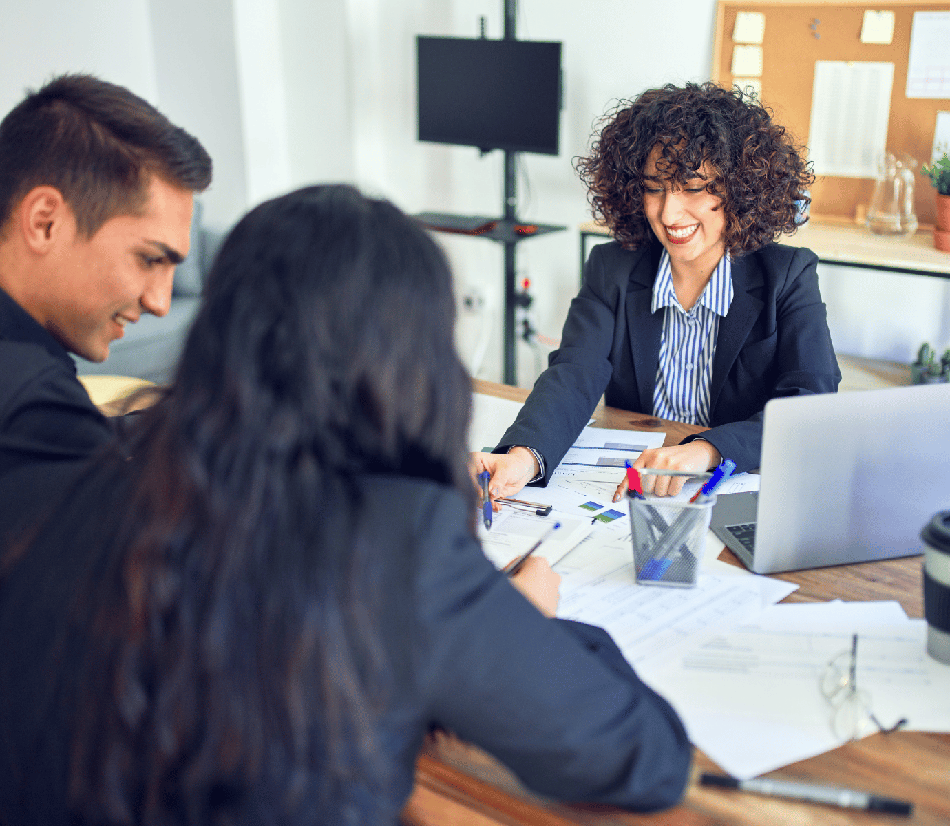 People Meeting in a Bank Office Smiling Signing Papers