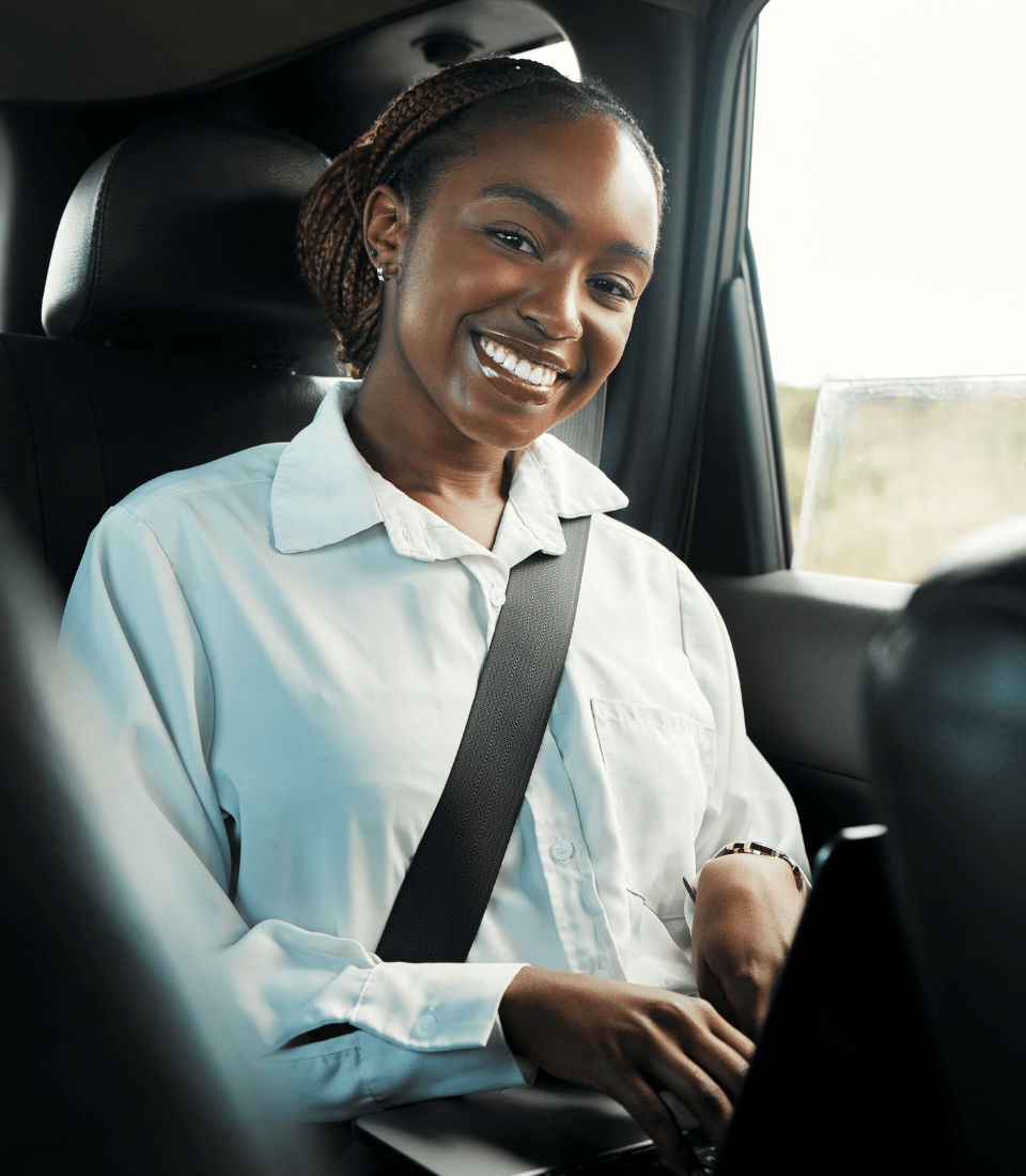 Young Woman on Laptop in Car