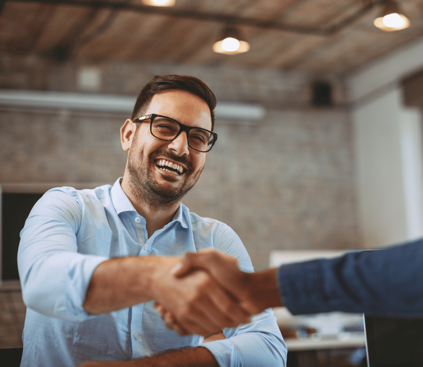 New Hire Shaking Hands and Smiling