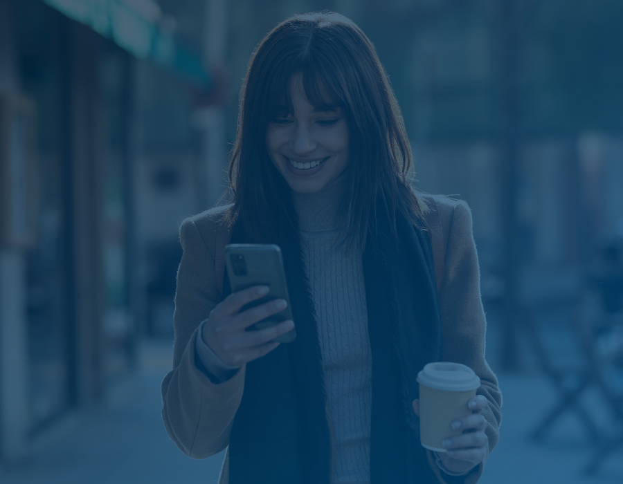 Consumer Survey SavvyMoney Consumer Survey Woman Walking Holding Coffee and Phone